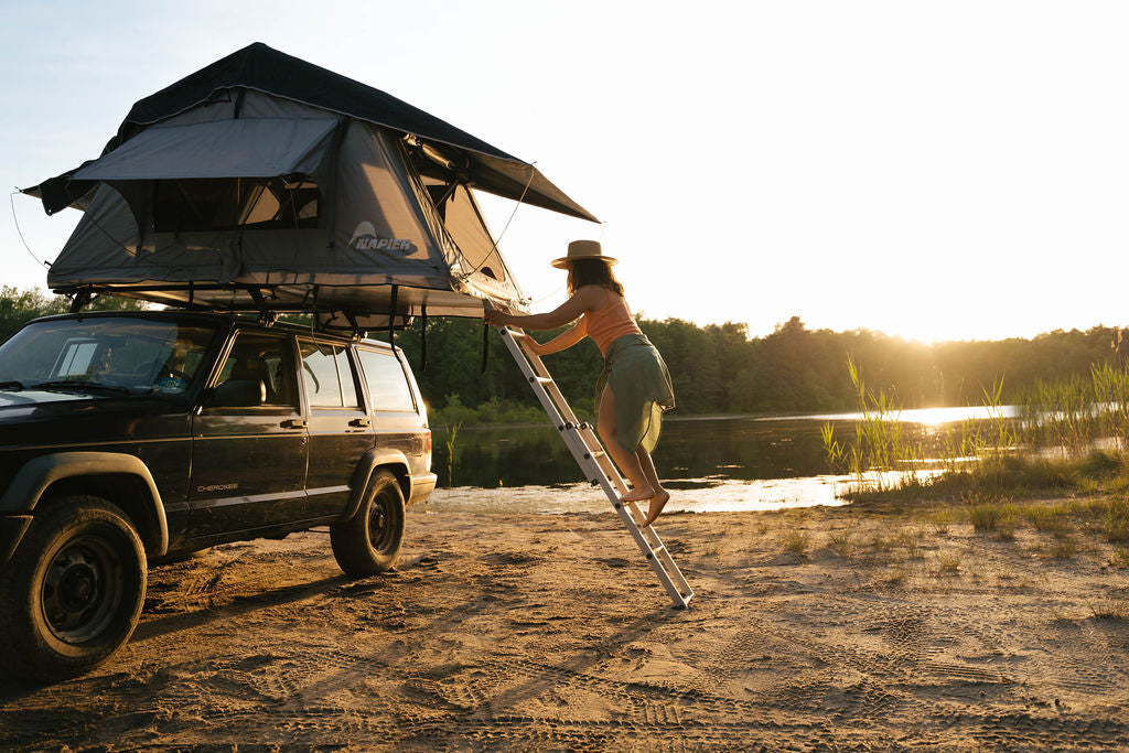 Napier rooftop tent mounted on an SUV at a campsite